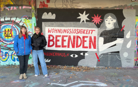 Frau Isa sprayt für neunerhaus-Kampagne „Wohnungslosigkeit beenden!“ am Wiener Donaukanal